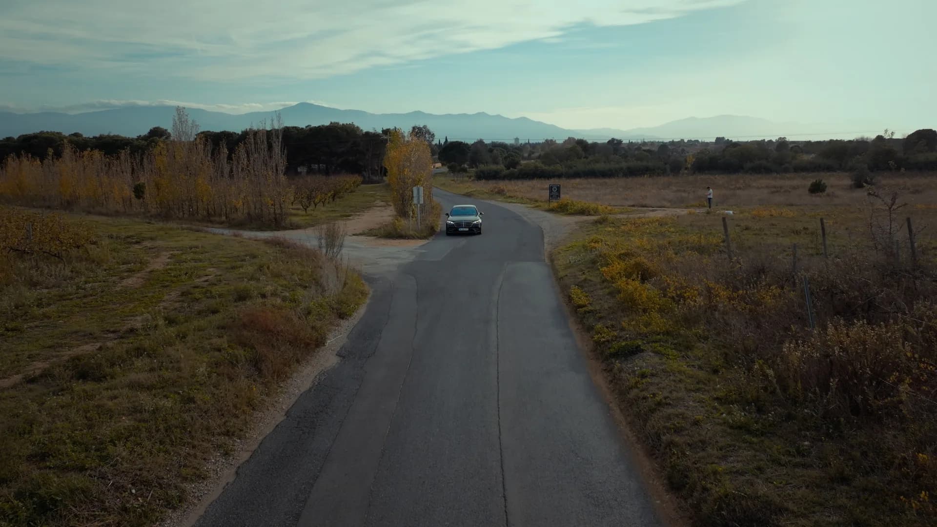 A car on a country road, filmed by drone