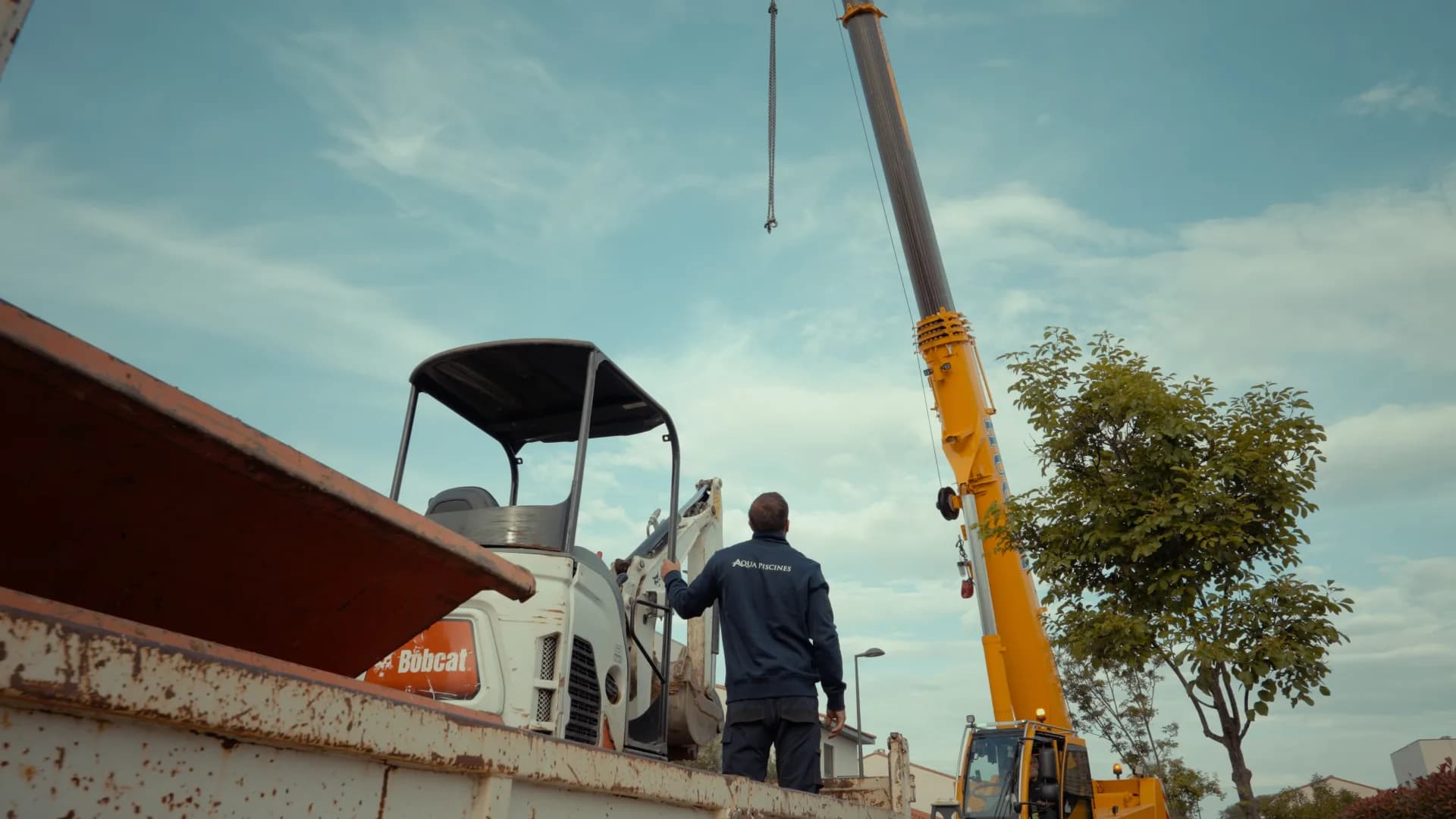 Mini digger and crane on a building site