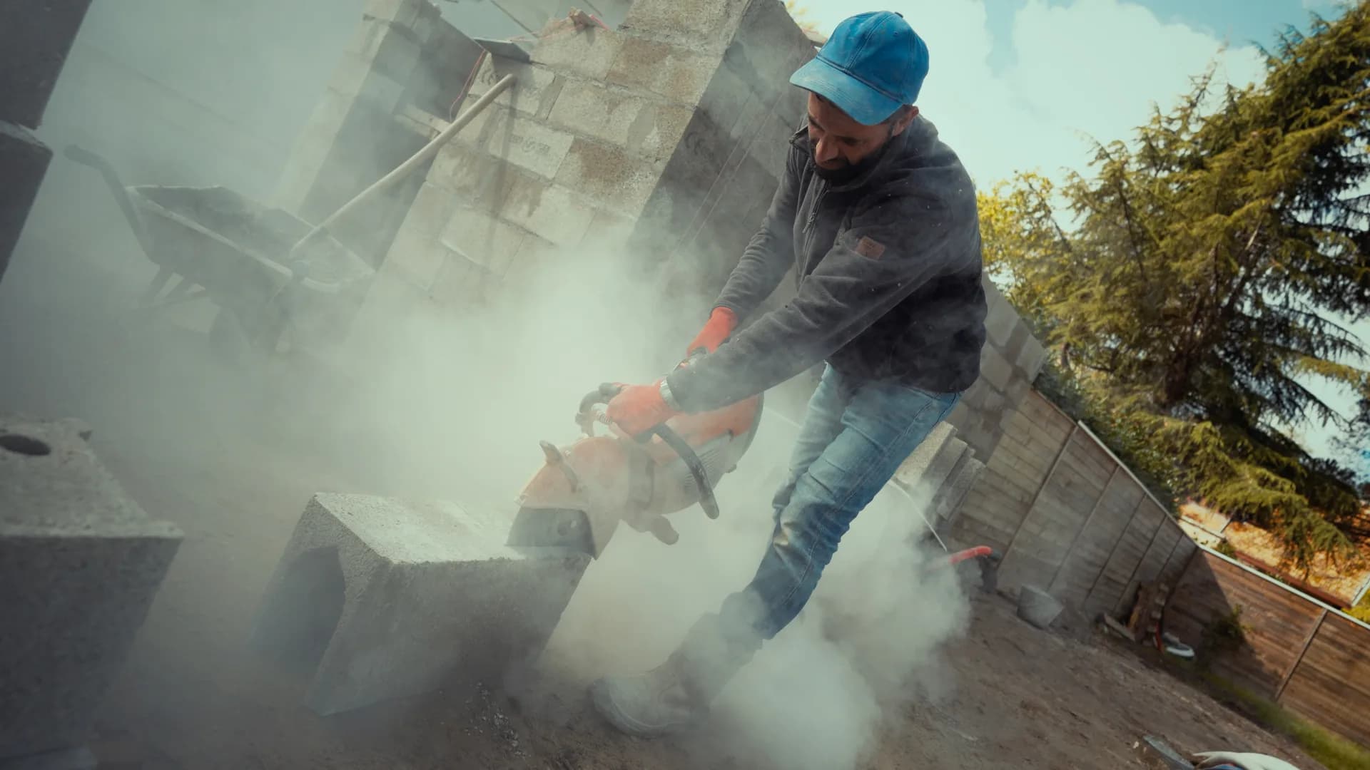 Cutting a breeze block in a cloud of dust