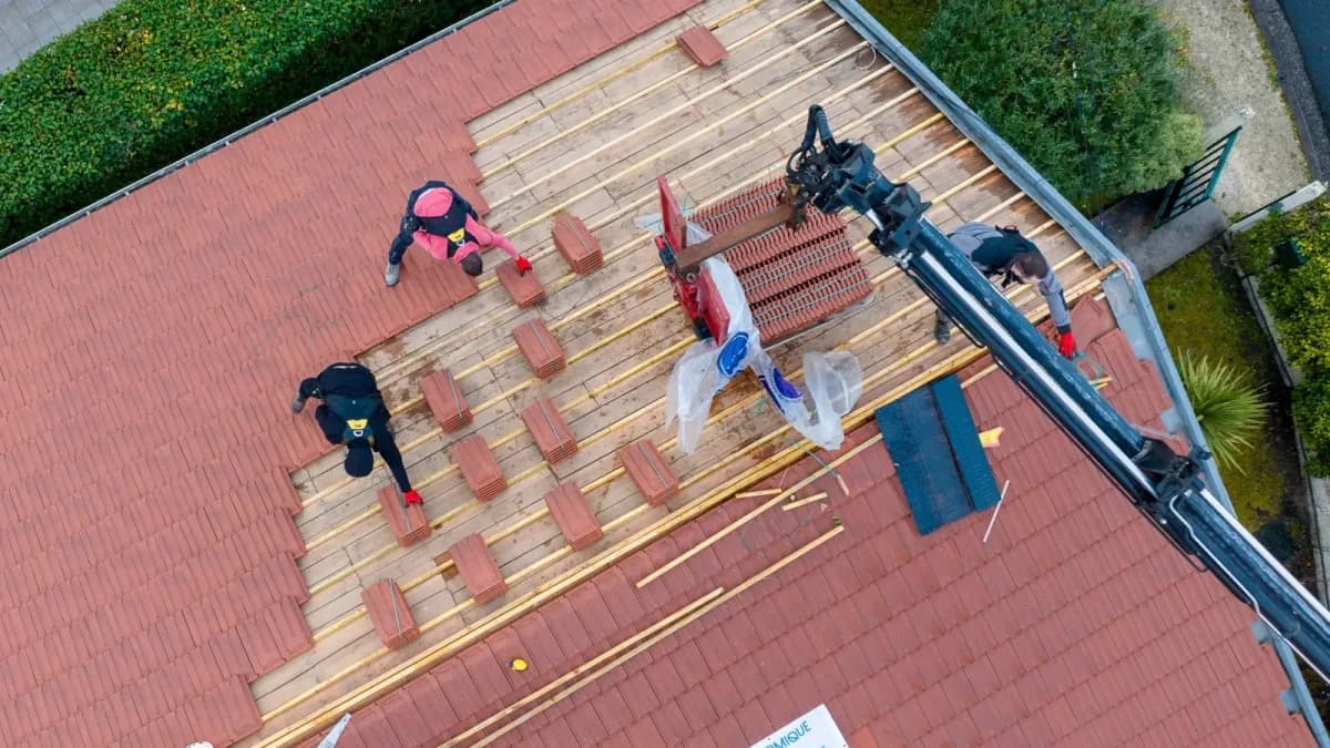 Roofers on a roof, seen from the drone