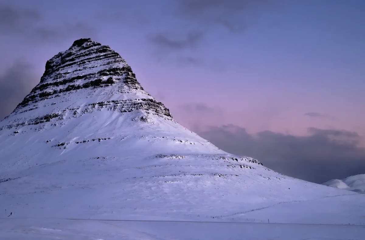 Snow-capped mountain at dusk
