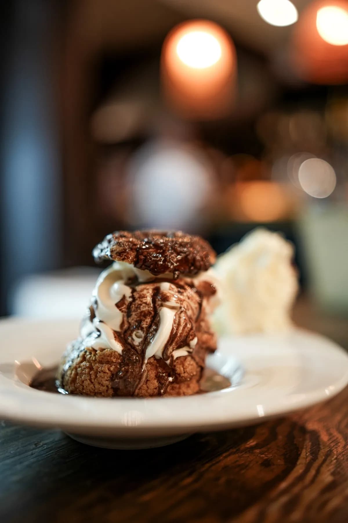 Chocolate dessert with whipped cream in a shallow bowl