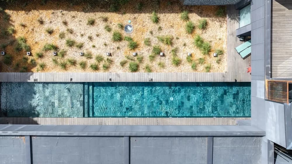 A long pool among dry grass, seen from above