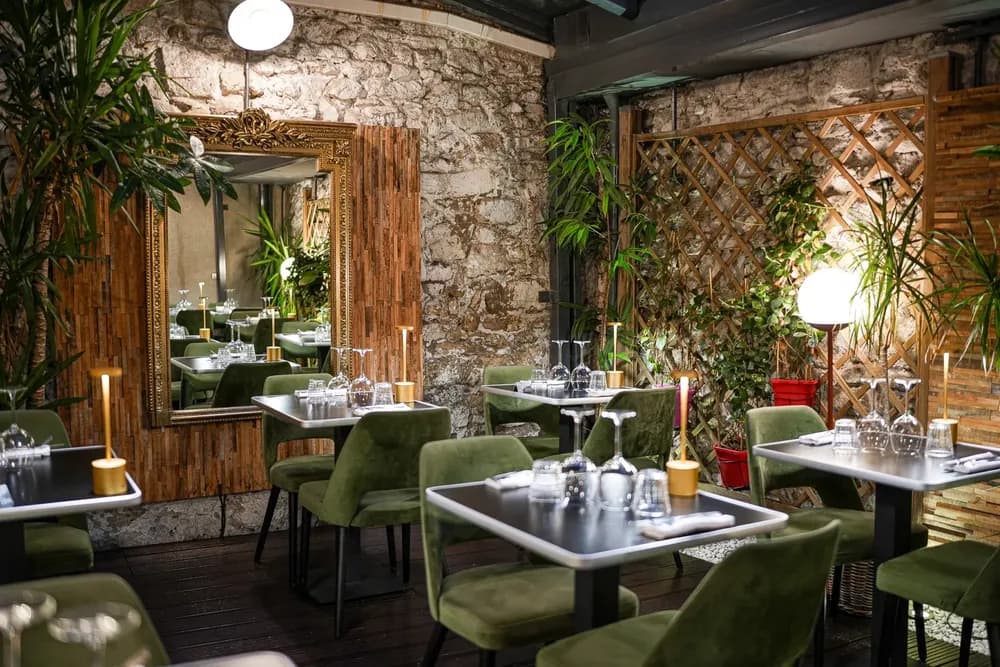 A restaurant dining room surrounded by plants