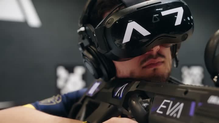 Player in a virtual reality headset holding an Eva game gun